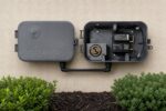 CELL-BOX cellular add-on mounted on a wall next to a Rachio outdoor controller enclosure