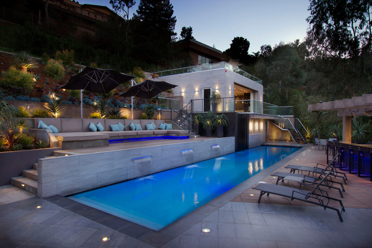 Luxury backyard pool and outdoor living space designed for discreet landscape audio
